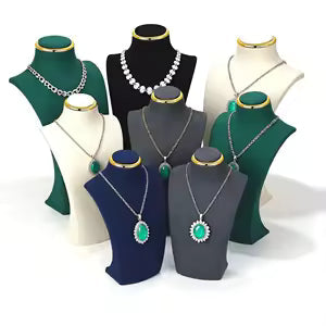 Collection of women's pendant necklaces displayed on a dark velvet jewelry tray, featuring gold and silver chain styles with gemstone and decorative pendants